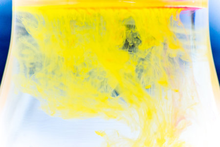 a drop of paint pouring in waterの写真素材