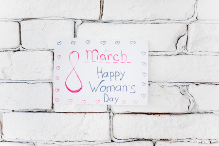 sticky note saying happy 8 march on the wallの写真素材