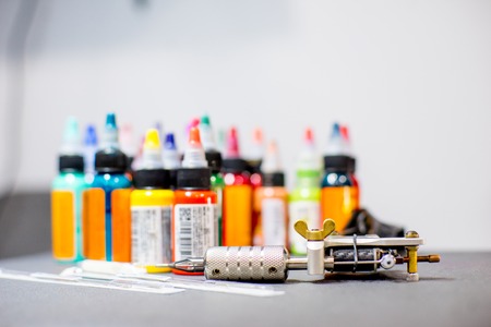 tattoo equipment machine and colorful ink in a workshopの写真素材