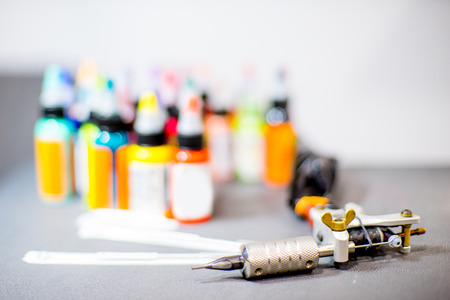 tattoo equipment machine and colorful ink in a workshopの写真素材