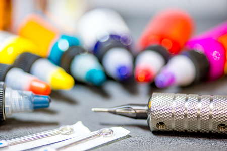 tattoo equipment machine and colorful ink in a workshopの写真素材