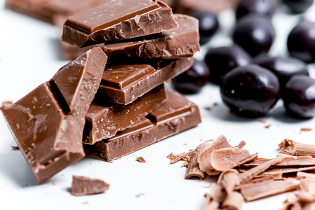 chocolate bar, shavings and cookies on a tableの写真素材