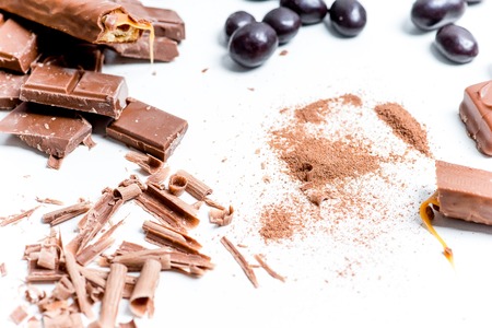 chocolate bar, shavings and cookies on a tableの写真素材