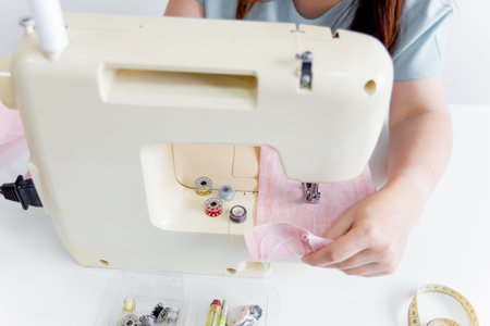 female hands are using a sewing machine
