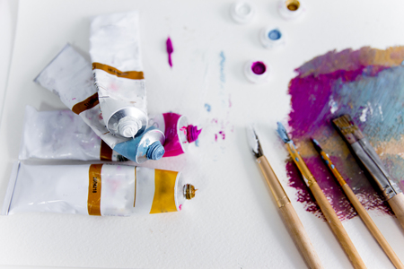 Artistic palette with paint brushes and oil paintの写真素材