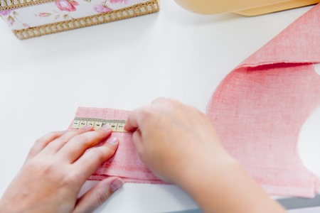 female hands are using a sewing machineの写真素材