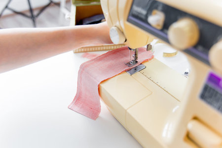 female hands are using a sewing machine