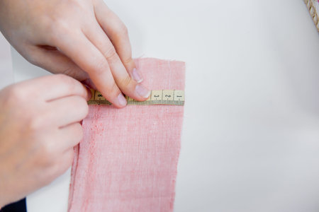 female hands are using a sewing machine