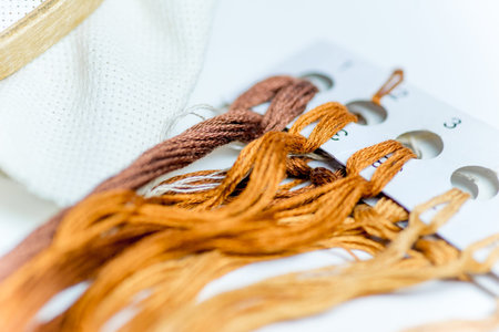 hands are sewing with thread and needle