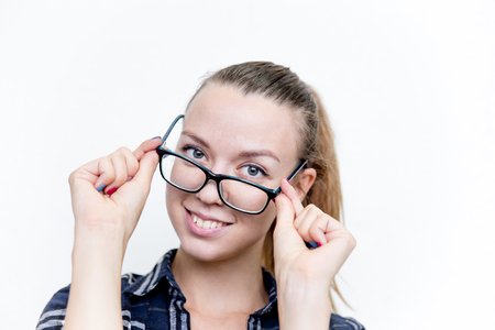 Young woman with bad eyesight with glasses and contact lensesの写真素材