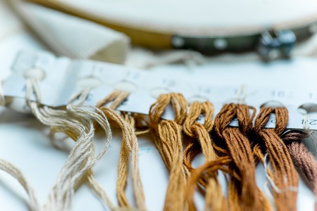 colorful sewing thread on a white tableの写真素材