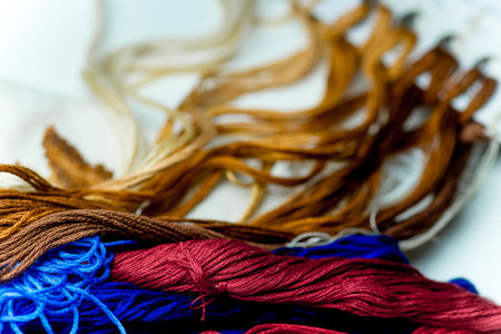 colorful sewing thread on a white table