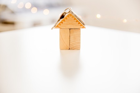 a model of a house with a bag of moneyの写真素材