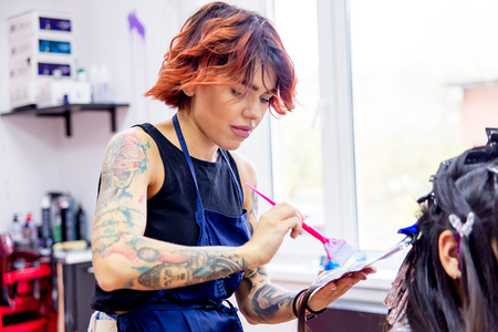 Professional hairdresser working with client in salonの写真素材