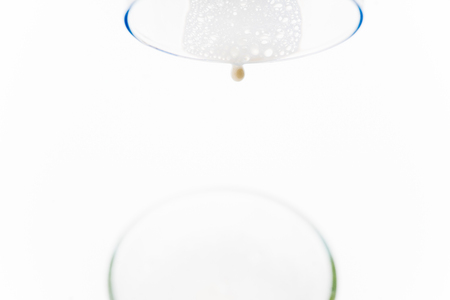 a glass of milk with bread and grainsの写真素材