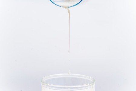 a glass of milk with bread and grainsの写真素材