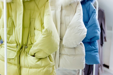 Fashion winter coats hanged on a clothes rackの写真素材