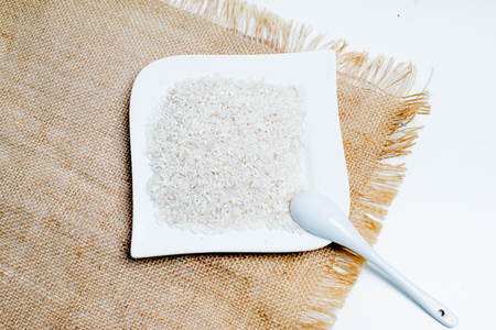 different types of groats in pots on a white backgroundの写真素材