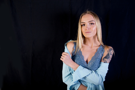 a studio shot of a young woman with tattooの写真素材