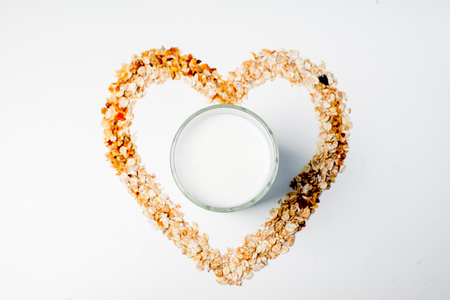 a glass of milk with bread and grainsの写真素材