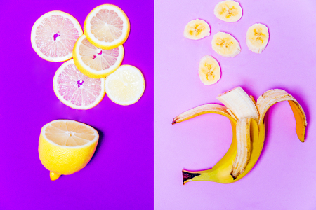 a banana and a lemon on colorful backgroundの写真素材