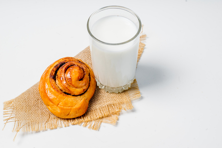 a glass of milk with bread and grainsの写真素材