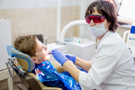 female dentist with a patient in a clinicの写真素材