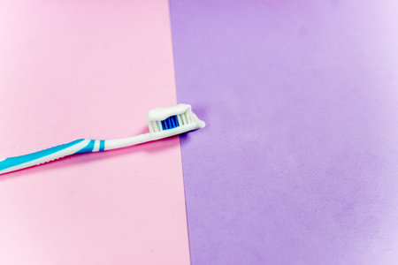 toothbrushes and a toothpaste on a colorful background