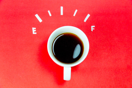 coffee is a fuel concept - a cup on a red backgroundの写真素材