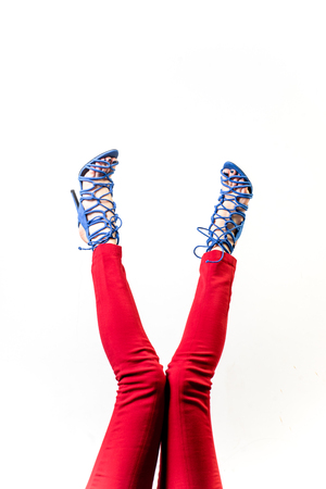Female legs in red trousers and shoesの写真素材