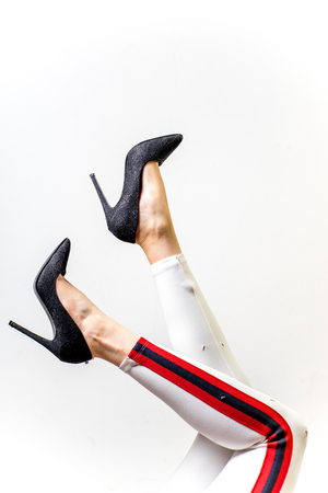 Female legs in white trousers and shoesの写真素材