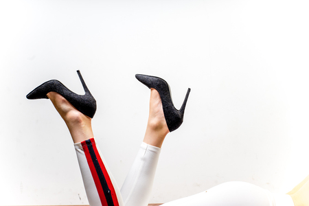 Female legs in white trousers and shoesの写真素材