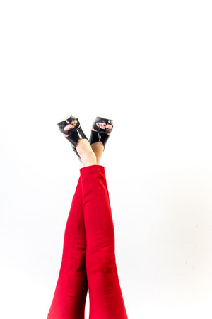 Female legs in red trousers and shoes