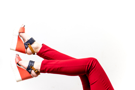 Female legs in red trousers and shoesの写真素材