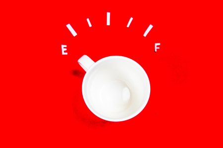coffee is a fuel concept - a cup on a red backgroundの写真素材
