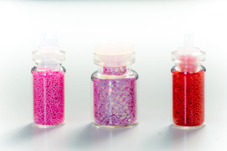 various colorful nail varnish in containers on a table