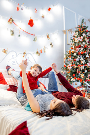 happy family is celebrating christmas together at homeの写真素材