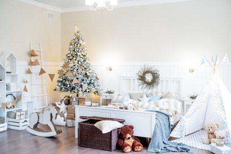 Christmas living room with a christmas tree and presents under itの写真素材