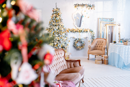 Christmas living room with a christmas tree and presents under itの写真素材