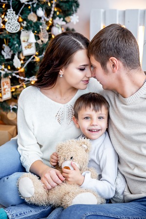happy family is celebrating christmas together at homeの写真素材