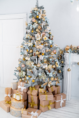 Christmas living room with a christmas tree and presents under itの写真素材