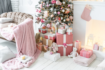 Christmas living room with a christmas tree and presents under itの写真素材