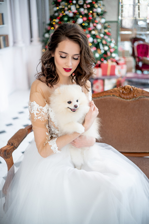 Beautiful young woman in an evening dress celebrating christmasの写真素材