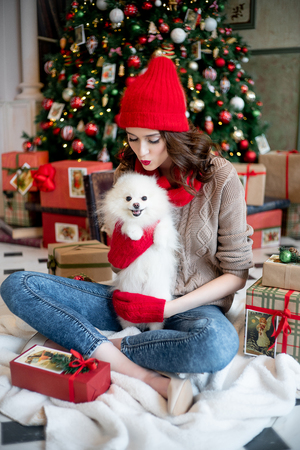 happy young woman is celebrating christmas at homeの写真素材