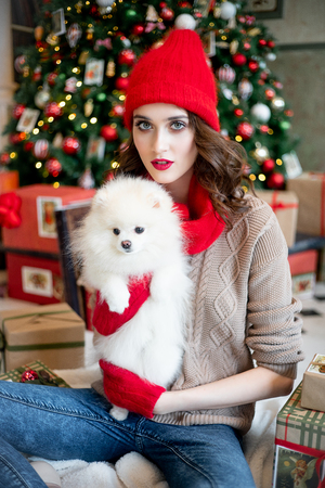 happy young woman is celebrating christmas at homeの写真素材