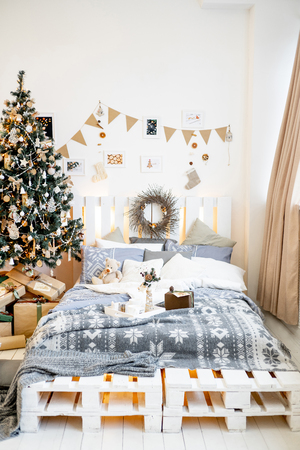 Christmas living room with a christmas tree and presents under itの写真素材