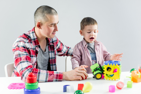 Dad and toddler son having fun playing at homeの写真素材