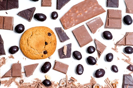 chocolate bar, shavings and cookies on a tableの写真素材