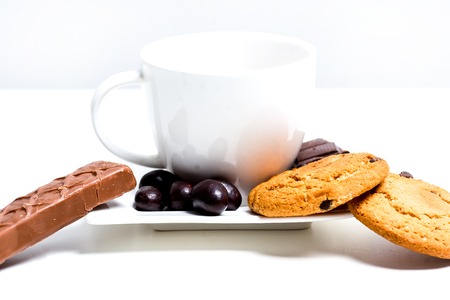 chocolate bar, shavings and cookies on a tableの写真素材
