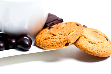 chocolate bar, shavings and cookies on a tableの写真素材
